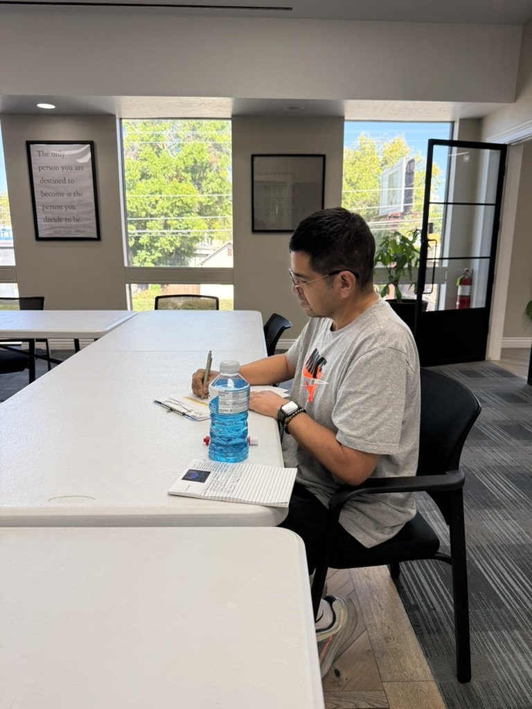 Felipe Ruiz, case manager, working at the group room table